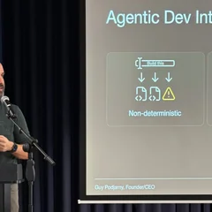 Man standing at podium presenting slide on Agentic Development